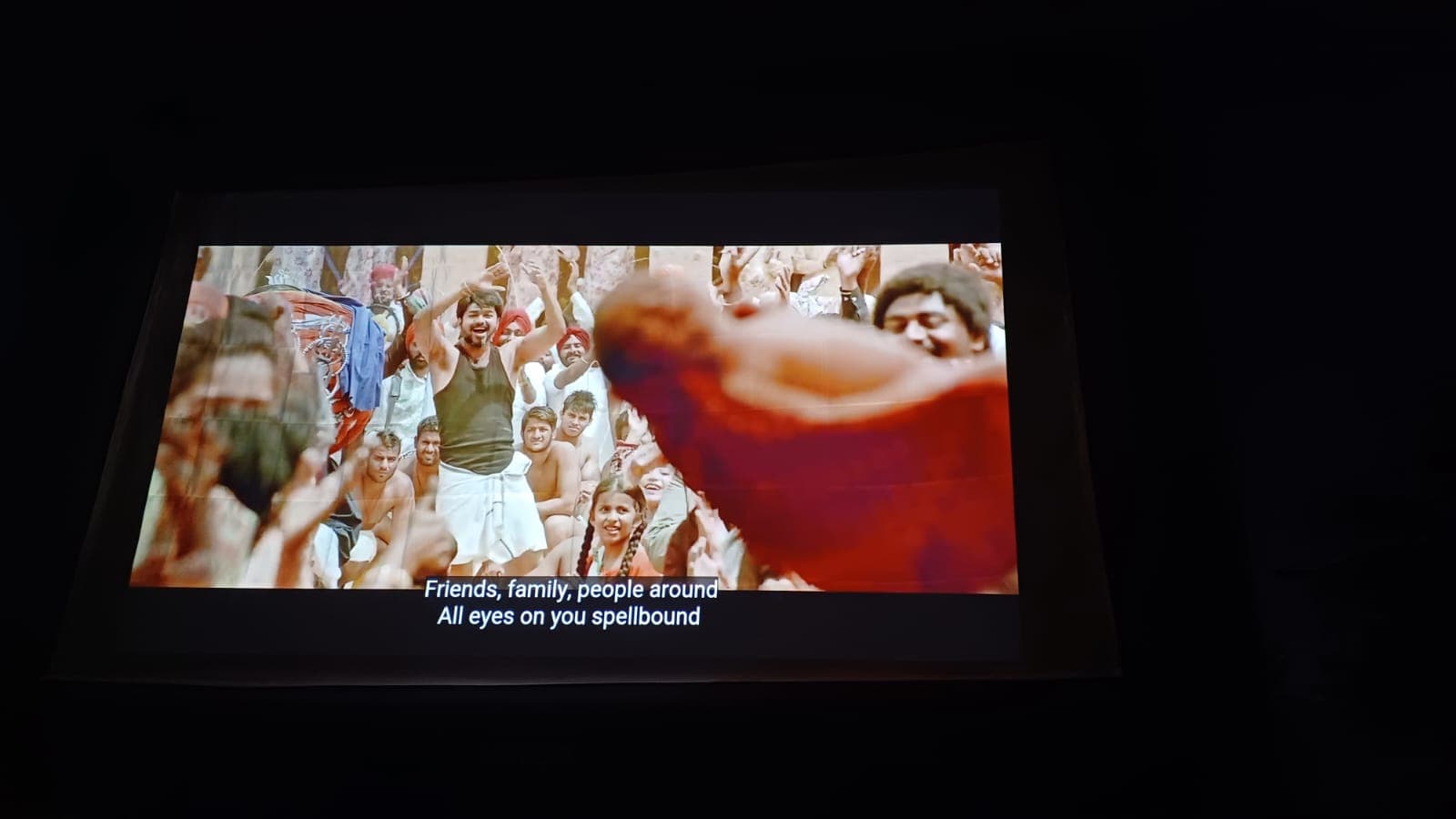 Outdoor cinema screening — crowd scene projected on inflatable screen